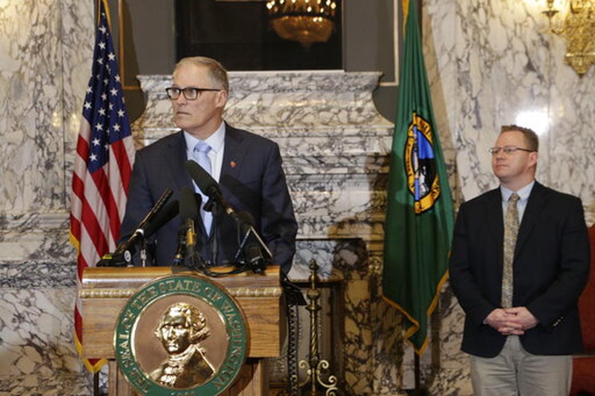 Washington Gov. Jay Inslee, left, is joined by Superintendent of Public Instruction Chris Reykdal as he discusses the expansion of school closures and prohibition of large gatherings across all of Washington in an effort to slow the spread of the new coronavirus, Friday, March 13, 2020. Inslee issued the executive orders, saying the virus is spreading rapidly across the state. Previously, school closures and prohibitions of large gatherings had only been ordered in the three counties with the highest numbers of cases.