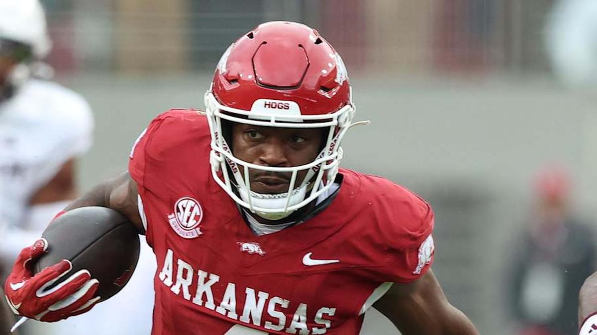  Oct 18, 2025; Fayetteville, Arkansas, USA; Arkansas Razorbacks running back Mike Washington Jr (4) rushes in the second quarter as Texas A&M Aggies cornerback Tyreek Chappell (7) and safety Dalton Brooks (25) defend at Donald W. Reynolds Razorback Stadium. Mandatory Credit: Nelson Chenault-Imagn Images | Nelson Chenault-Imagn Images 