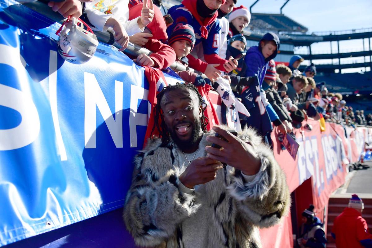  Dec 1, 2024; Foxborough, Massachusetts, USA; WWE superstar Kofi Kingston takes a selfie with fans prior to a game between the New England Patriots and Indianapolis Colts at Gillette Stadium. Mandatory Credit: Bob DeChiara-Imagn Images 