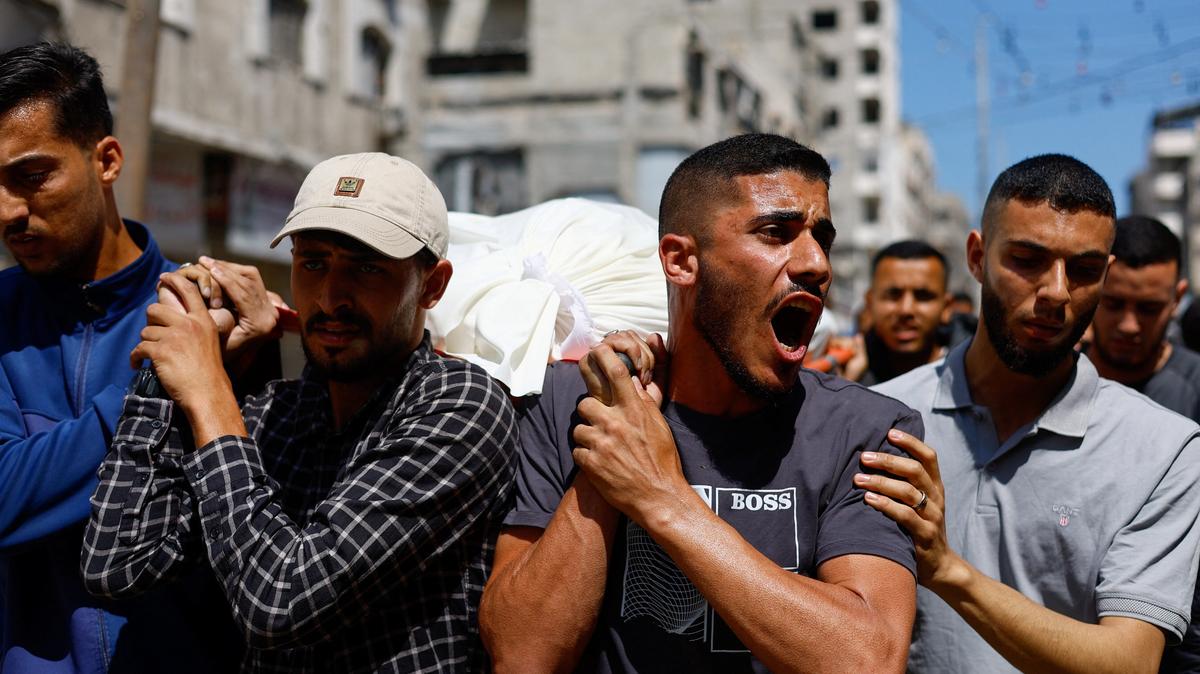 People carry bodies identified by mourners as Hamas' military wing commander Mohammad Odeh, who was killed in an Israeli strike on Tuesday, and his wife and children, during a funeral, in Gaza City, May 27, 2026. REUTERS/Mahmoud Issa