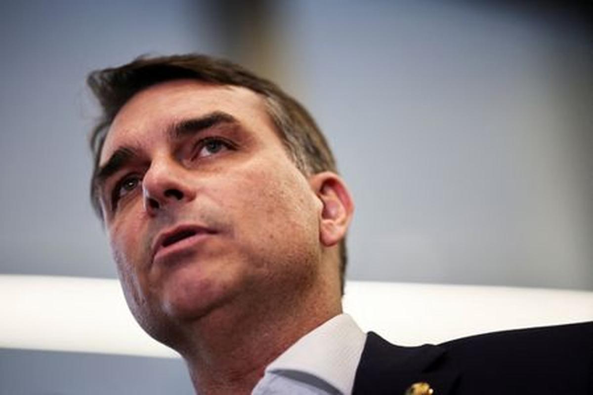 Flavio Bolsonaro speaks with members of the press after a meeting, following a scandal over messages tied to his request for funding for a biopic about former Brazilian President Jair Bolsonaro, from disgraced banker Daniel Vorcaro, who was arrested in March on suspicion of leading a multibillion-dollar fraud scheme, in Brasilia, Brazil, May 19, 2026. REUTERS/Mateus Bonomi