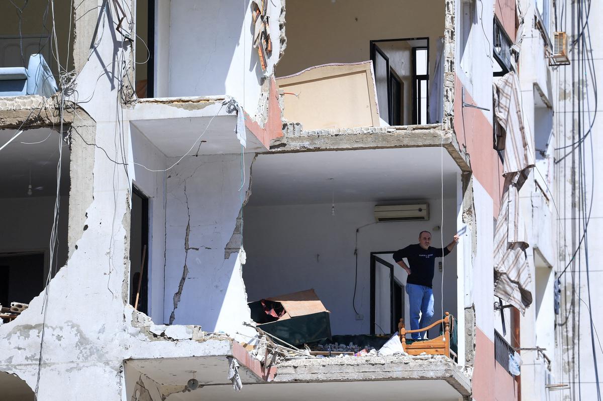 A man stands in his house, damaged in an Israeli strike that took place before a temporary ceasefire went into effect, in the southern suburbs of Beirut, Lebanon. REUTERS/Mohamed Azakir