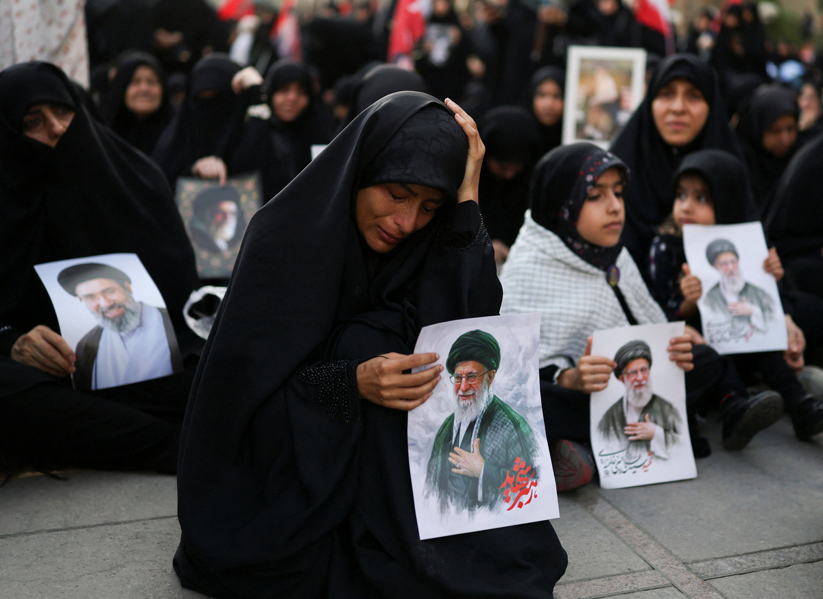 A woman reacts as she holds an image of late Supreme Leader Ayatollah Ali Khamenei, on the day of a public farewell ceremony to pay respects to Khamenei, who was killed on February 28 in Israeli and U.S. airstrikes, at the Imam Khomeini Grand Mosalla, in Tehran, Iran July 4, 2026.  REUTERS/Mohammed Salem  Foreign media in Iran operate under guidelines set by the Ministry of Culture and Islamic Guidance, which regulates press activity and permissions