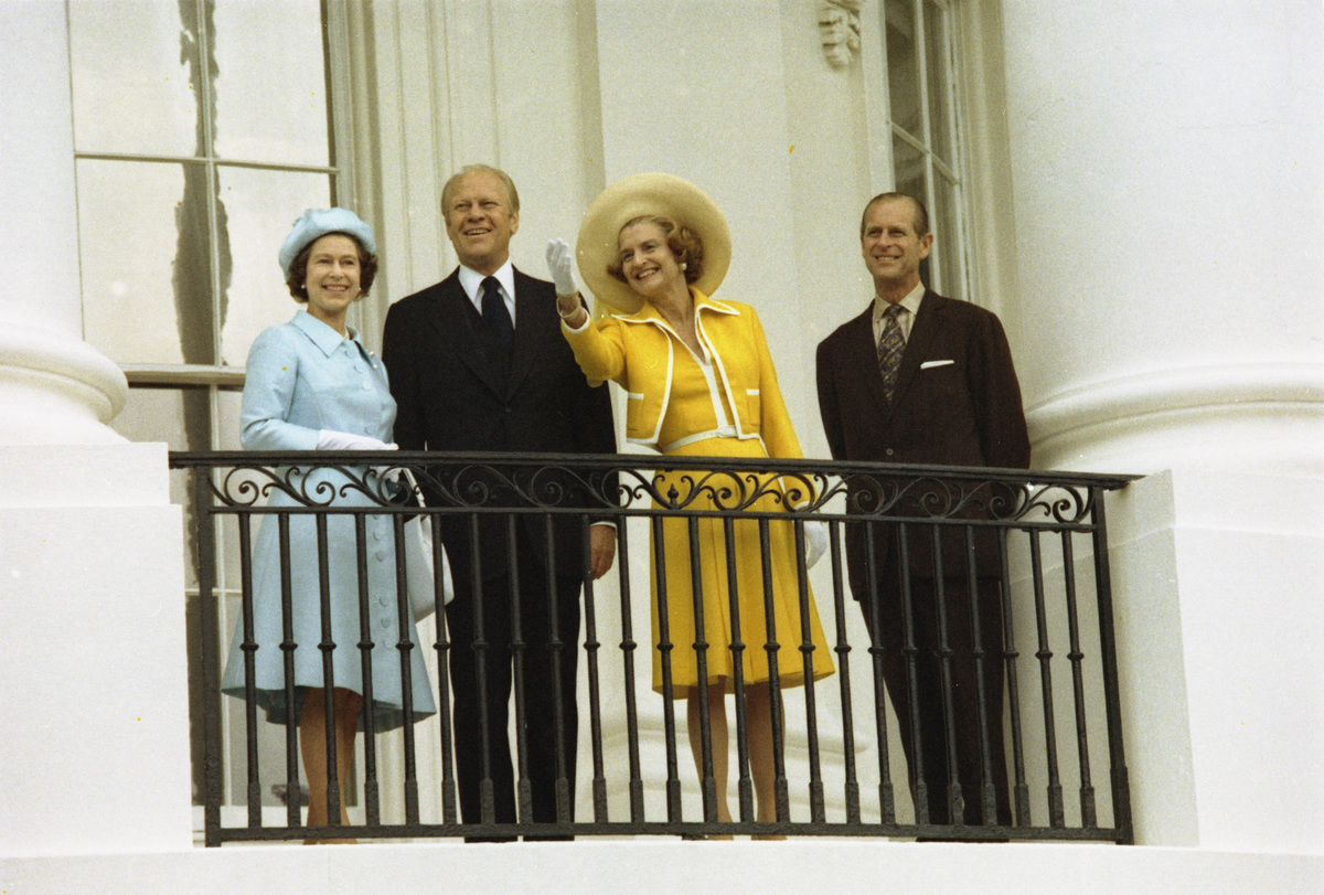 President Gerald Ford and first lady Betty Ford (center), with visiting British Queen Elizabeth II and Prince Philip, greet the public from the White House in Washington, DC, on July 7, 1976.