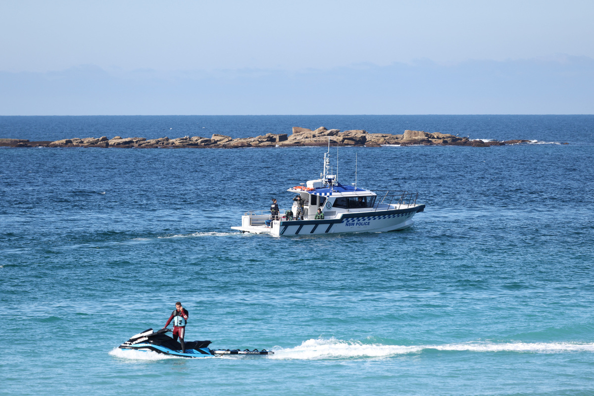 A lifeguard and a NSW Police boat patrol Coogee Beach following a shark attack in Sydney, Australia, June 13, 2026. REUTERS/Hollie Adams
