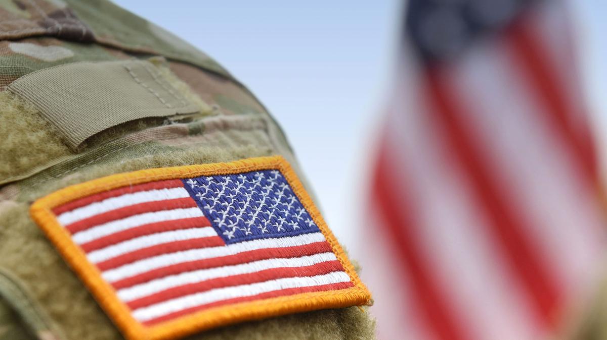 Stock image/file photo: USA patch flag on a military uniform. 