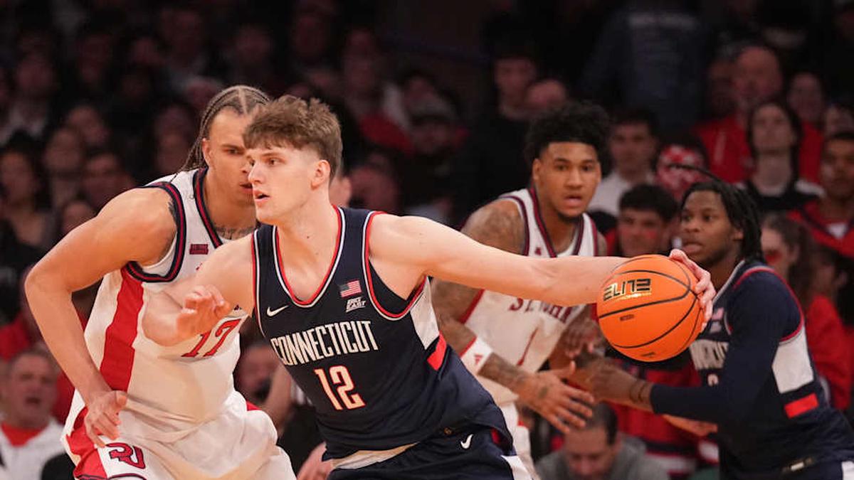 Mar 14, 2026; New York, NY, USA; Connecticut Huskies center Eric Reibe (12) works around St. John's Red Storm forward Rubén Prey (17) during the first half of the men's Big East Conference Tournament Championship at Madison Square Garden. Mandatory Credit: Robert Deutsch-Imagn Images | Robert Deutsch-Imagn Images 