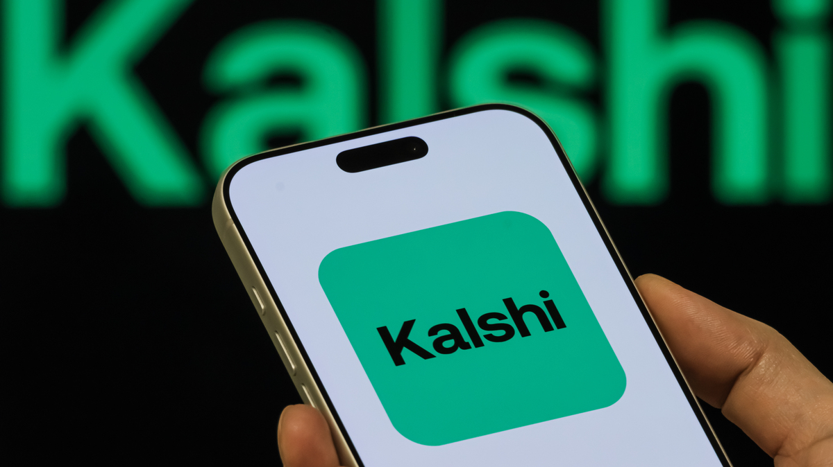 Kalshi App Icon Shown On Smartphone With Kalshi Branding In Background. In this photo illustration, a person holds a smartphone displaying the Kalshi app icon, with the Kalshi branding visible in the background, on February 8, 2026, in Chongqing, China. 
