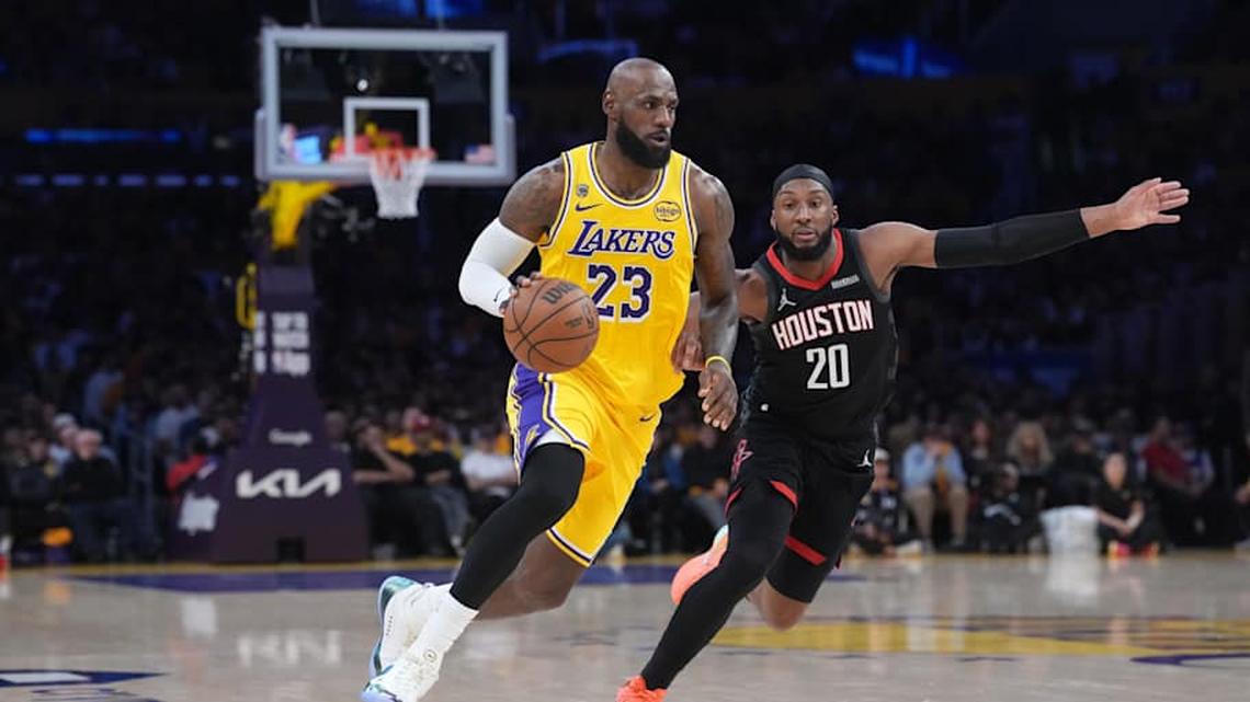  Lakers forward LeBron James drives to the basket against Rockets guard Josh Okogie. | Kirby Lee-Imagn Images 