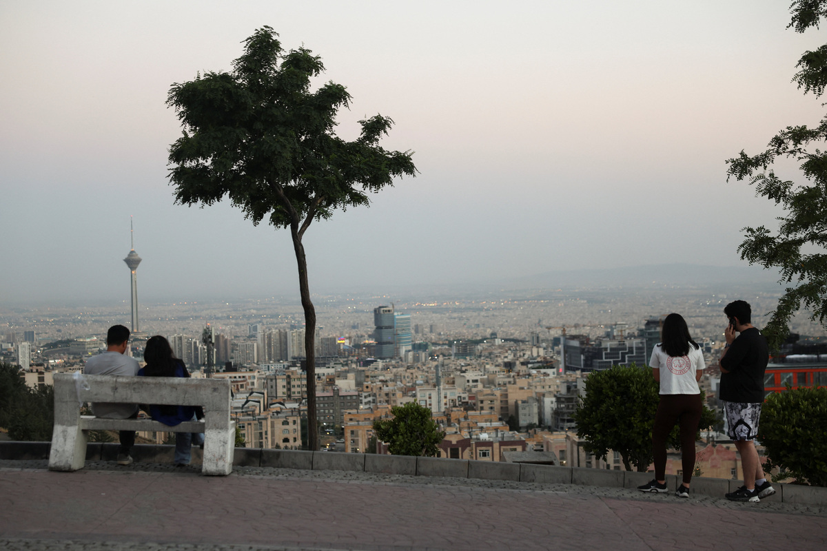 Iranian people in a park with a view of Milad Tower, in Tehran, Iran, June 15, 2026. Majid Asgaripour/WANA (West Asia News Agency) via REUTERS