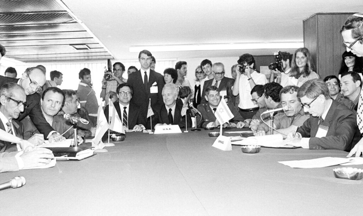  Chief Lebanese negotiator Antoine Fattal, left, and Israeli chief negotiator David Kimche, right, sign an Israeli troop withdrawal agreement in Khalde, Lebanon, on May 17, 1983. AP Photo/Bill Foley 
