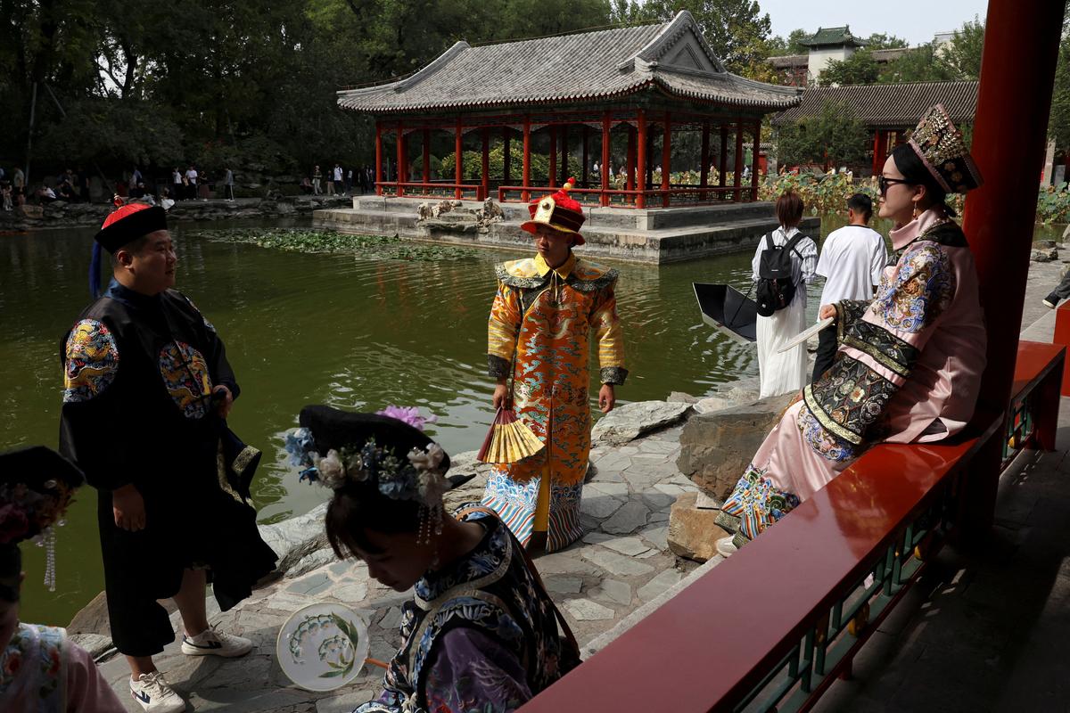 FILE PHOTO: Tourists wearing Qing dynasty costumes visit Prince Kung's Mansion on National Day, the first day of China's eight-day Golden Week holiday, in Beijing, China October 1, 2025. REUTERS/Florence Lo/File Photo