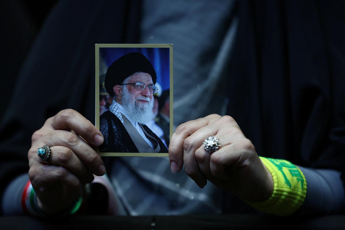 A woman holds a picture of the late Supreme Leader of Iran, Ayatollah Ali Khamenei, during a rally in Tehran, Iran, May 6, 2026. Majid Asgaripour/WANA (West Asia News Agency) via REUTERS