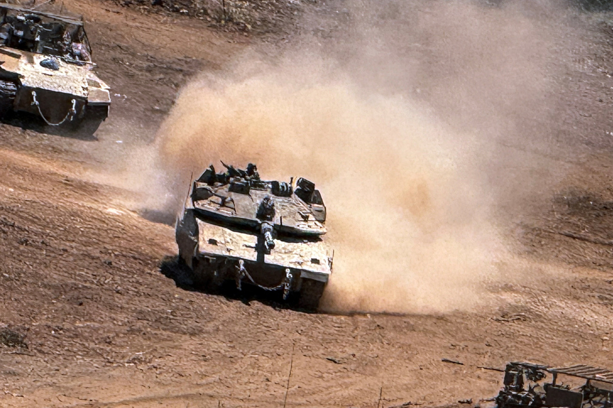 An Israeli tank and an APC maneuver on the Israeli side of the Israel-Lebanon border, after crossing the border into Israel, July 1, 2026. Picture taken with a mobile phone. REUTERS/Avi Ohayon