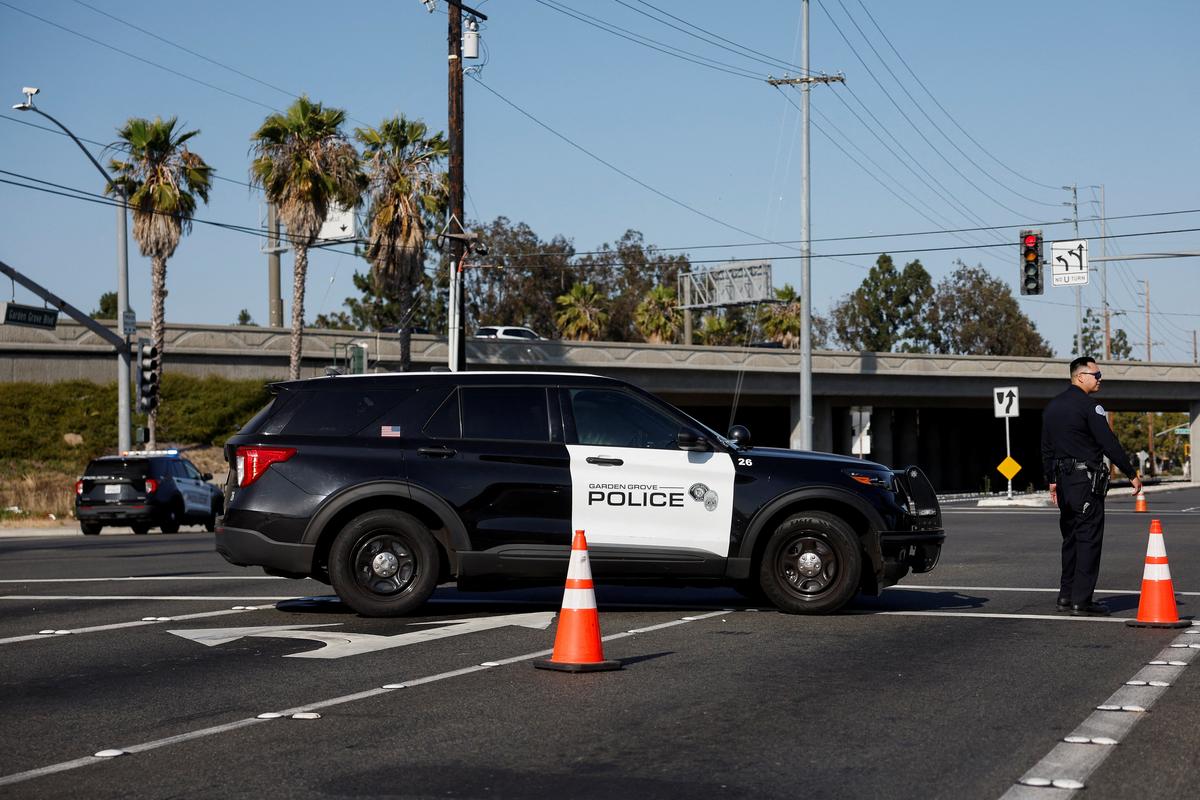 Police vehicles block a roadway as a chemical incident involving a failing tank of flammable liquid called methyl methacrylate, used in the aerospace industry, has forced an evacuation in the surrounding area in Garden Grove, California, U.S. May, 22, 2026. REUTERS/ Caroline Brehman