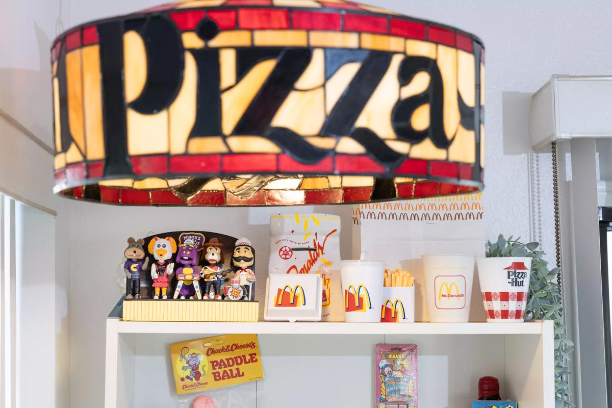 A Pizza Hut pendant illuminates McDonald’s collectibles in the ’80s & ’90s Food Culture Hall of Fame dining room. 