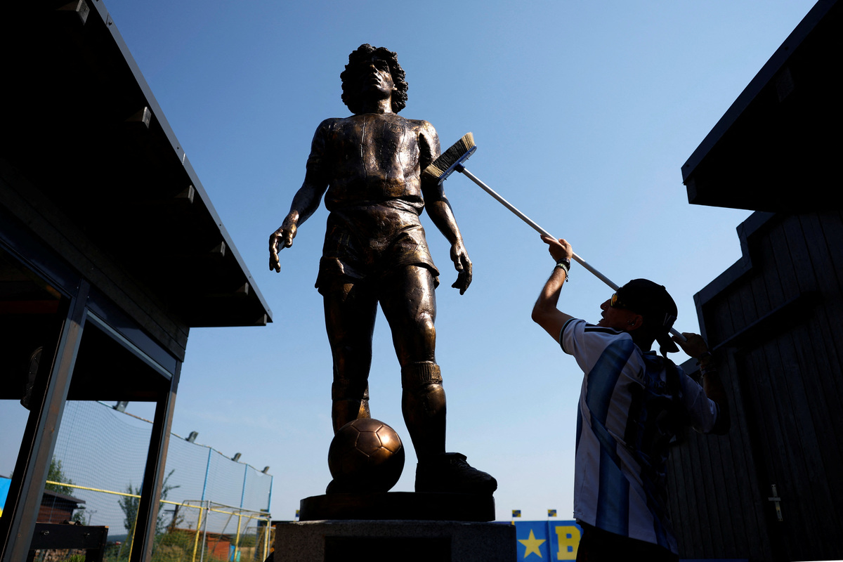 Miloslav "Curby" Urbanec, a 51-year-old Czech national and an ardent Argentine football fan, cleans a statue of Diego Maradona at a yard of his house in the village of Bukovka near the town of Lazne Bohdanec, Czech Republic, June 29, 2026. REUTERS/David W Cerny