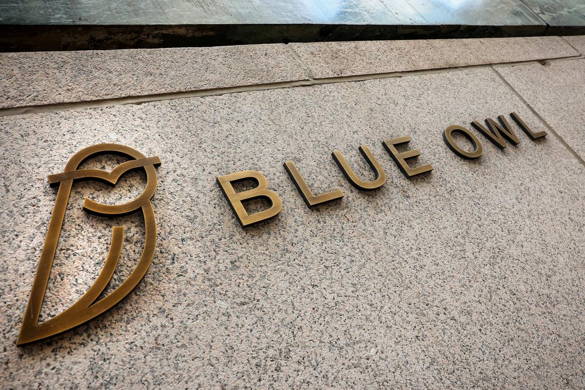 FILE PHOTO: A logo for Blue Owl Capital is displayed on a midtown Manhattan office building in New York City, U.S., February 24, 2026.  REUTERS/Brendan McDermid/File Photo