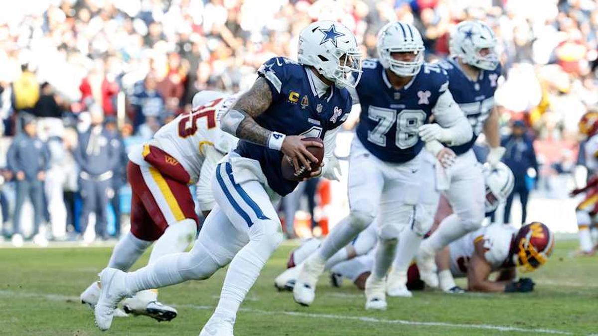  Dec 25, 2025; Landover, Maryland, USA; Dallas Cowboys quarterback Dak Prescott (4) scrambles with the ball defended by Washington Commanders defensive tackle Jer'Zhan Newton (95) in the second quarter at Northwest Stadium. Mandatory Credit: Geoff Burke-Imagn Images | Geoff Burke-Imagn Images 