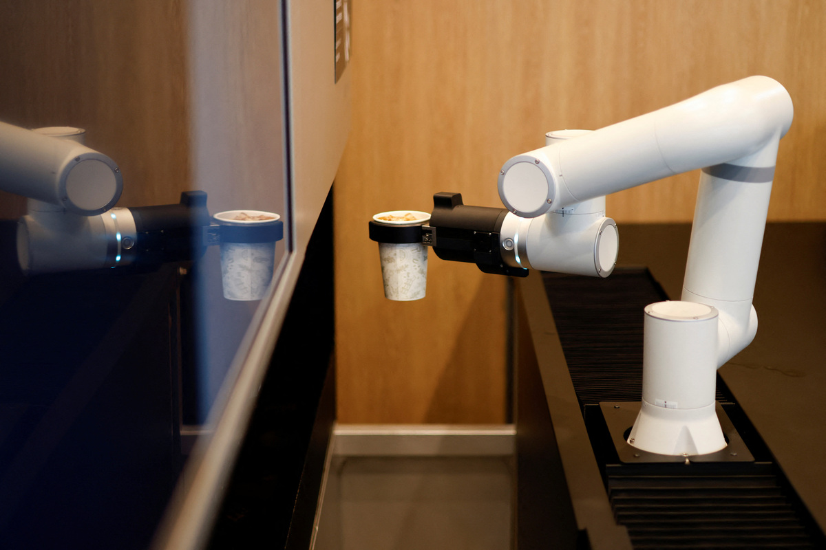 A robot arm prepares coffee at an unmanned cafe in Seoul, South Korea, June 19, 2026. REUTERS/Kim Soo-hyeon