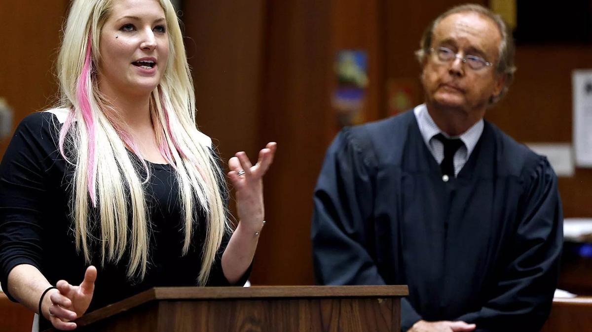 Mariann Avery of Los Angeles spent 15 months in the drug court program before graduating in December 2014. She described to the crowd how it changed her life. Watching is Judge Michael Tynan.