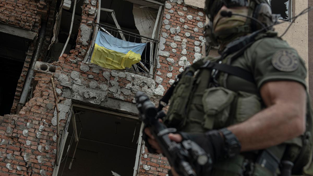 A Ukrainian serviceman near a destroyed building in Irpin, Ukraine on July 11.