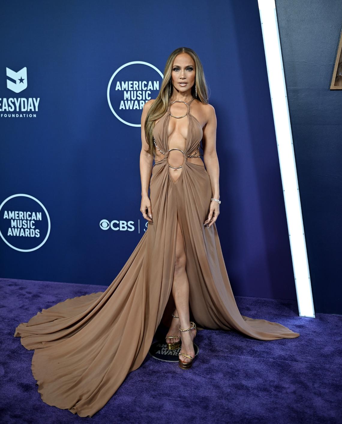Jennifer Lopez The hostest with the mostest Jennifer Lopez was the star of the show in a light brown draped gown with a peek-a-boo neckline. Denise Truscello/WireImage