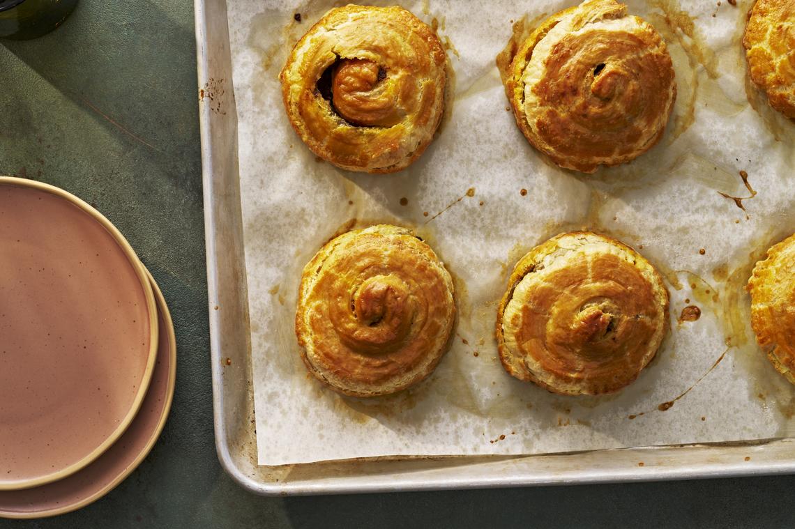 An egg wash mixed with turmeric helps give the beef patties their golden hue. Yewande Komolafe's version, inspired by the chef Paul Carmichael, chases the brilliant balance of the original. Food Stylist: Barrett Washburne. (Andrew Bui/The New York Times)