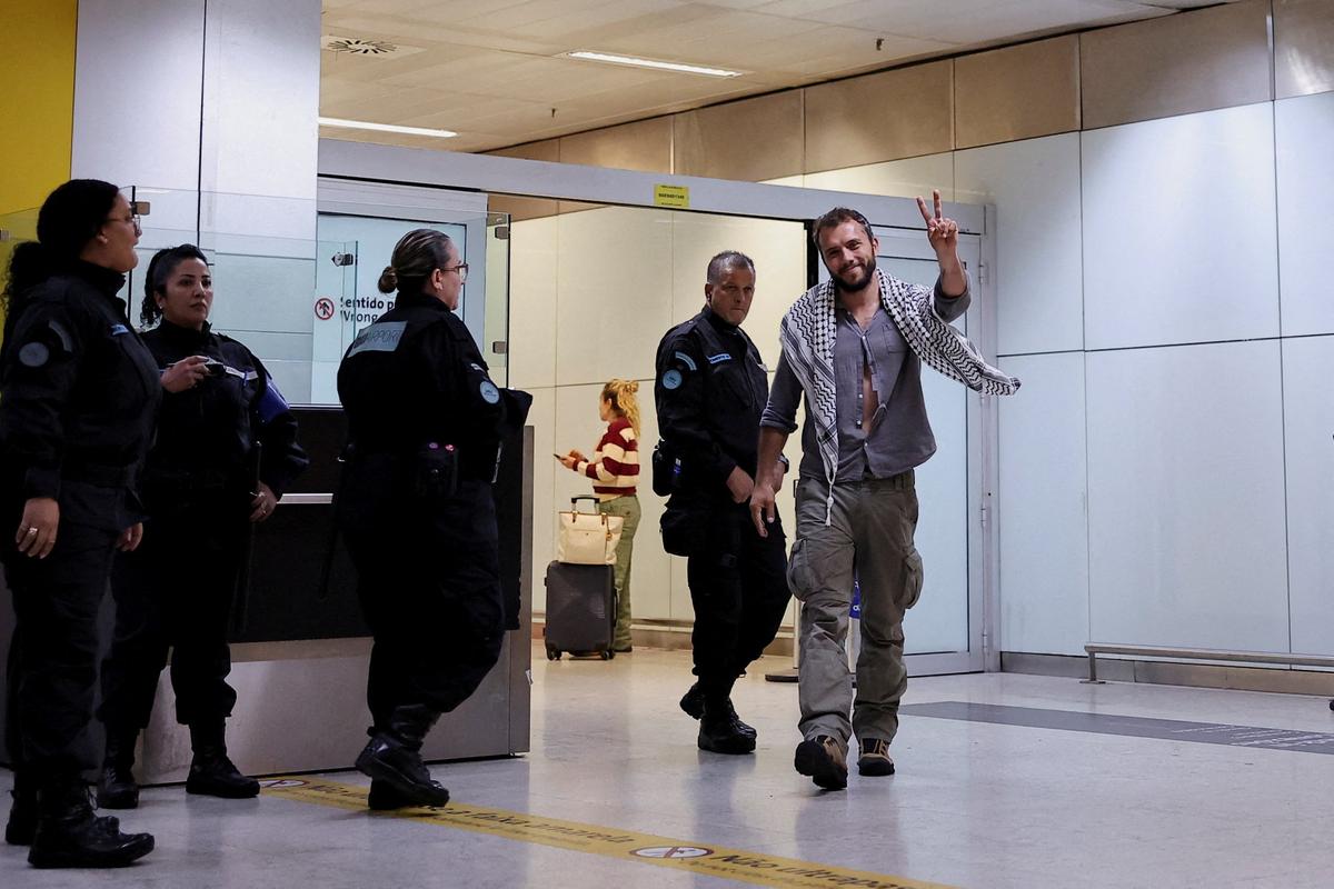 Brazilian activist Thiago Avila, who was detained aboard the Gaza-bound Global Sumud Flotilla, which was intercepted by Israeli forces, gestures as he arrives at Sao Paulo/Guarulhos International Airport after being deported, in Guarulhos, Brazil, May 11, 2026. REUTERS/Amanda Perobelli