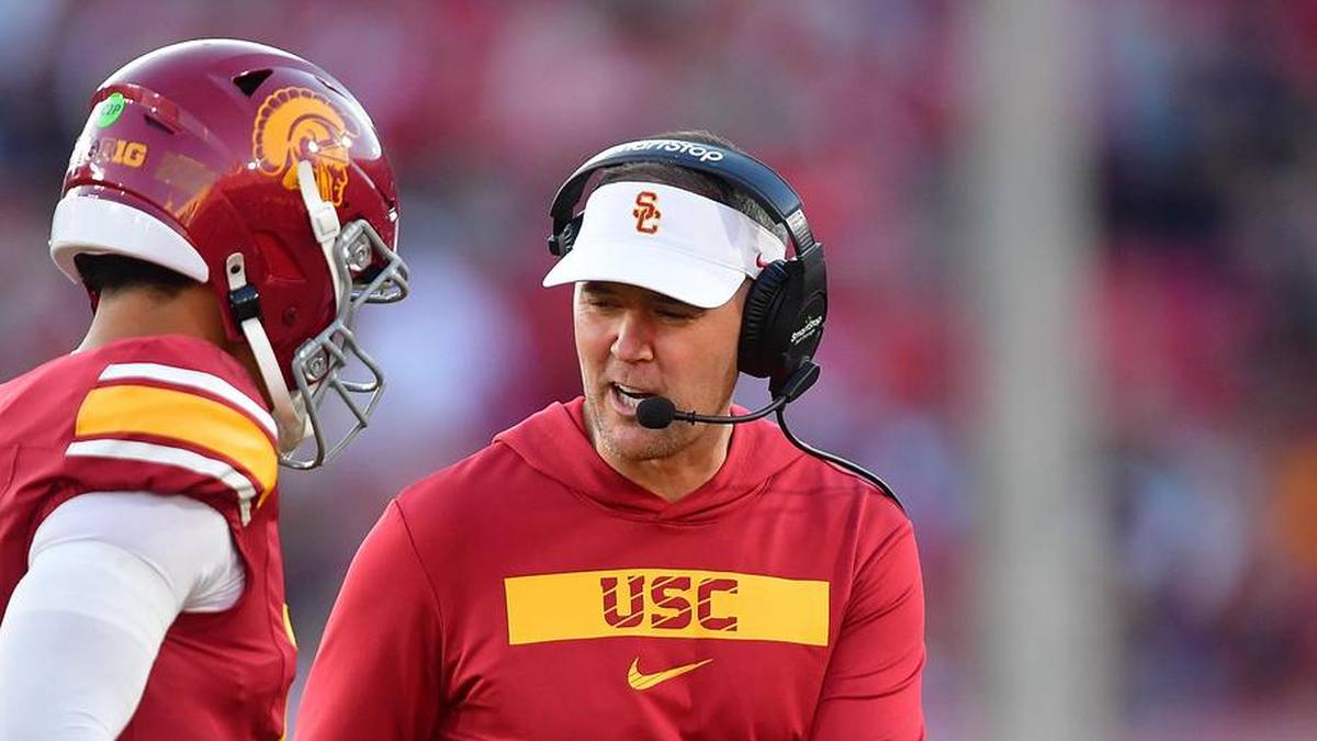  Nov 16, 2024; Los Angeles, California, USA; Southern California Trojans head coach Lincoln Riley greets quarterback Jayden Maiava (14) after scoring a touchdown against the Nebraska Cornhuskers during the second half at the Los Angeles Memorial Coliseum. Mandatory Credit: Gary A. Vasquez-Imagn Images | Gary A. Vasquez-Imagn Images 