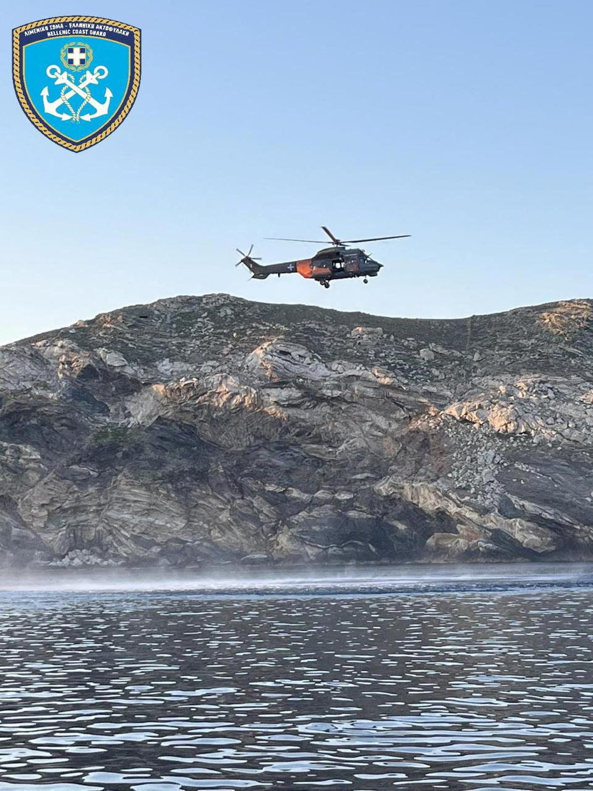 A Hellenic Coast Guard handout shows a helicopter flying as part of a rescue operation after a cargo ship ran aground and sank off the island of Andros, Greece, May 6, 2026. Hellenic Coast Guard/Handout via REUTERS.