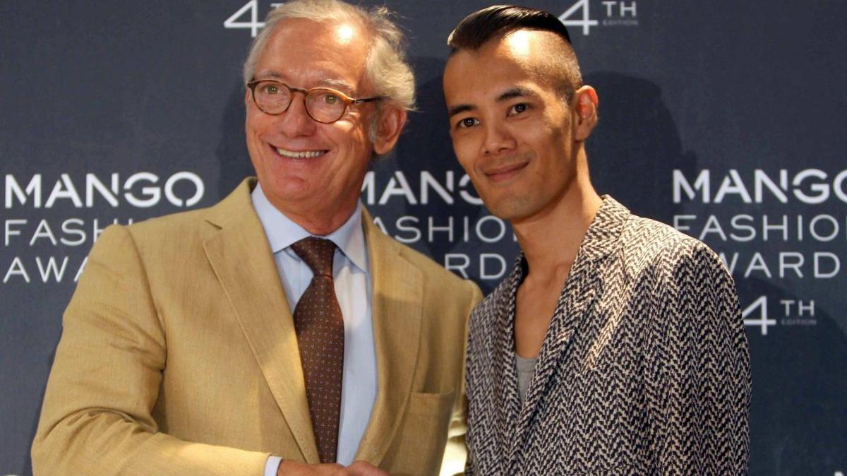 President of Spanish fashion brand Mango Isak Andic, left, shakes hands with Thai fashion designer Wisharawish Akaransantisook, after Akaransantisook was awarded the Mango Fashion Award in Barcelona in 2012. Andic fell to his death in 2024 on a hiking trip with his son, Jonathan Andic. Catalonian police arrested Jonathan Andic Tuesday in connection with his father's death. File Photo by Toni Albir/EPA