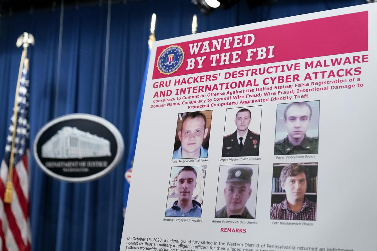  A Department of Justice poster shows six GRU officers charged with cyberattacks, Oct. 19, 2020. Andrew Harnik/Pool via Getty Images 