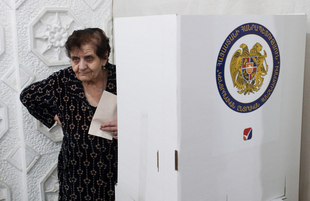 A voter holds a ballot at a polling station during a parliamentary election in Yerevan, Armenia, June 7, 2026. Vahram Baghdasaryan/Photolure via REUTERS