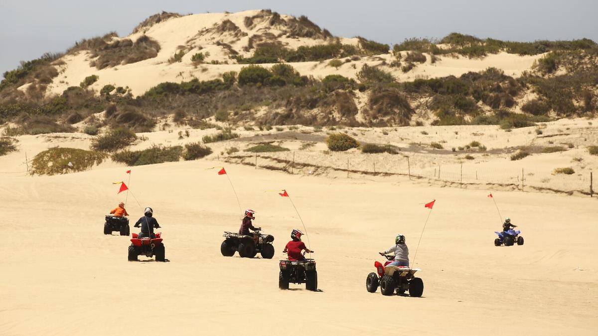 OCEANO, CA - JULY 03, 2019 - Riders of all ages enjoy the sand at The Oceano Dunes, a few miles south of Pismo Beach off Highway 1, as a major destination for off-roaders and campers. They arrive in trucks, trailers and RVs and other vehicles, motoring down a ramp onto the beach to access the "Sand Highway," to make camp July 3, 2019. Oceano Dunes State Park, one of the state's most popular parks draws about 2 million visitors a year. On busy weekends and holidays, reservations for its 1,000 sandy campsites fill up six months in advance. The California Coastal Commission is considering a move to scale back, and potentially eliminate, off-roading at the Oceano Dunes, the only state park on the California coast where you can still ride off-road vehicles. The decision stems from decades of controversy over off roading's impact on sensitive dune habitat, endangered birds and air quality for nearby residents. (Al Seib / Los Angeles Times)