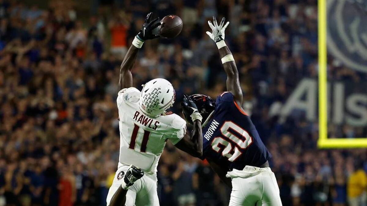  Sep 26, 2025; Charlottesville, Virginia, USA; Florida State Seminoles defensive back Ja'Bril Rawls (11) attempts to catch a pass intended for Virginia Cavaliers running back Xavier Brown (20) at Scott Stadium. Mandatory Credit: Geoff Burke-Imagn Images | IMAGN IMAGES via Reuters Connect 