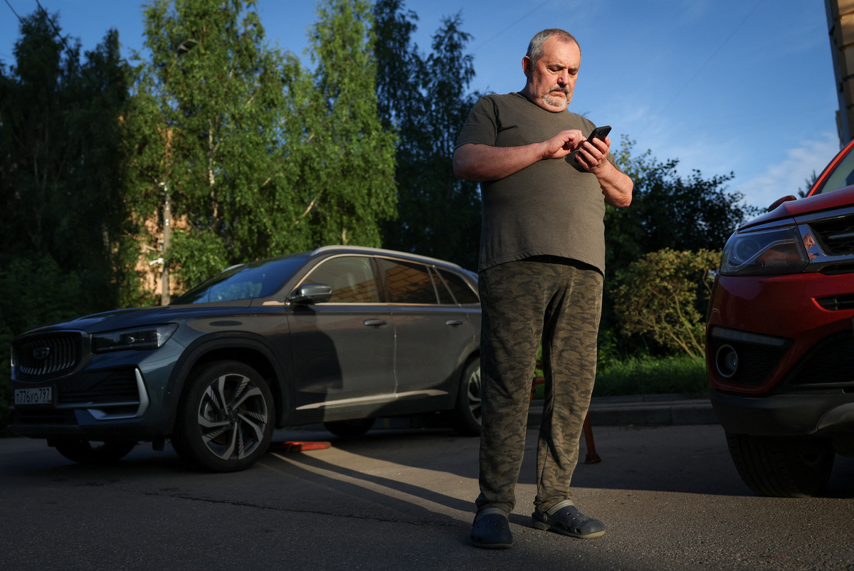 Boris Nadezhdin, an anti-war Russian politician, checks his phone after he has been released from police station in Dolgoprudny, Moscow region, Russia July 13, 2026.  REUTERS/Ramil Sitdikov