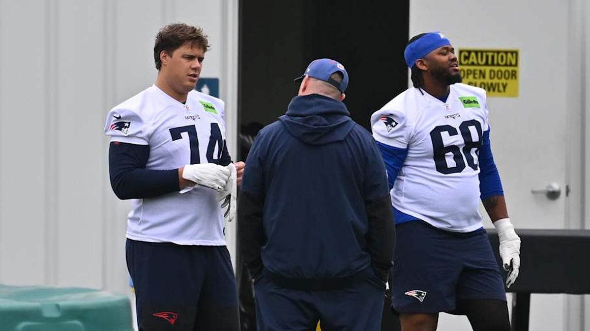  May 9, 2026; Foxborough, MA, USA; New England Patriots rookie tackle Caleb Lomu (74) talks to a member of the coaching staff at the New England Patriots rookie camp at Gillette Stadium. Mandatory Credit: Eric Canha-Imagn Images | Eric Canha-Imagn Images 