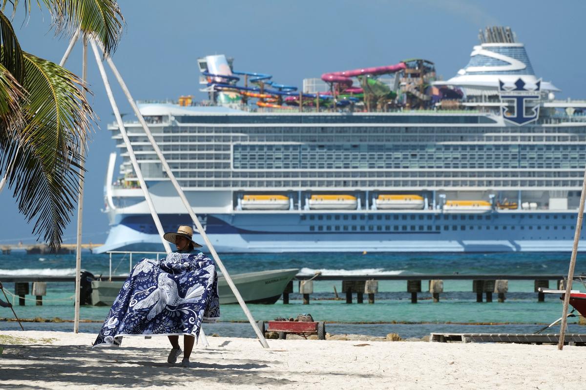 A vendor sells on the beach, in front of Royal Caribbean's Star of the Seas cruise ship, after Mexican authorities rejected a large water park planned for the area by Royal Caribbean, at the Costa Maya Cruise Port in Mahahual, Quintana Roo state, Mexico May 20, 2026. REUTERS/Paola Chiomante