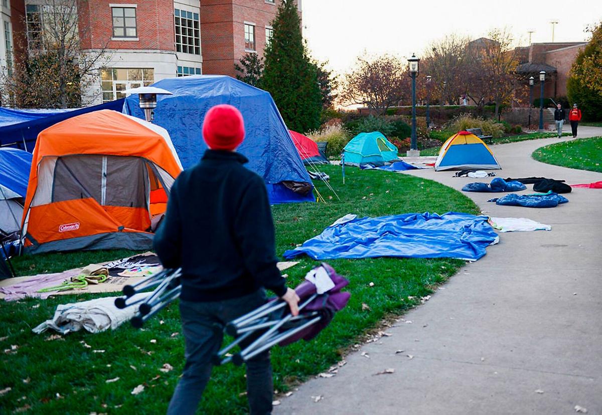 A person walks by the Concerned Student 1950 tent camp on Nov. 8, 2015, along Mel Carnahan Quadrangle on the University of Missouri campus in Columbia. The camp almost doubled in size the day after the Mizzou football team backed the group's boycott. On the evening of Nov. 7, 2015, MU players vowed to not play another game until then-UM System President Tim Wolfe resigned. A statement from then-Mizzou football coach Gary Pinkel said the team would not practice until Jonathan Butler ended his hunger strike.