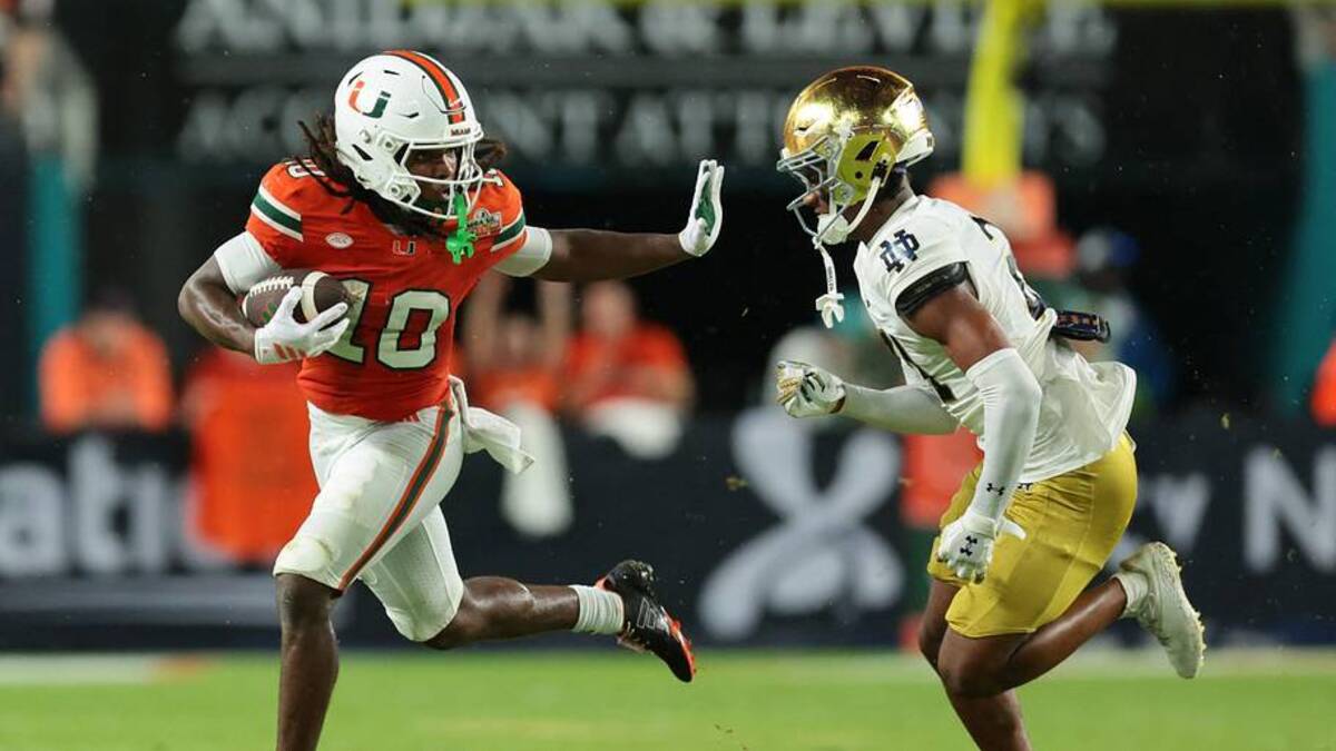  Aug 31, 2025; Miami Gardens, Florida, USA; Miami Hurricanes wide receiver Malachi Toney (10) runs with the football against Notre Dame Fighting Irish cornerback Karson Hobbs (21) during the first half at Hard Rock Stadium. Mandatory Credit: Sam Navarro-Imagn Images | IMAGN IMAGES via Reuters Connect 