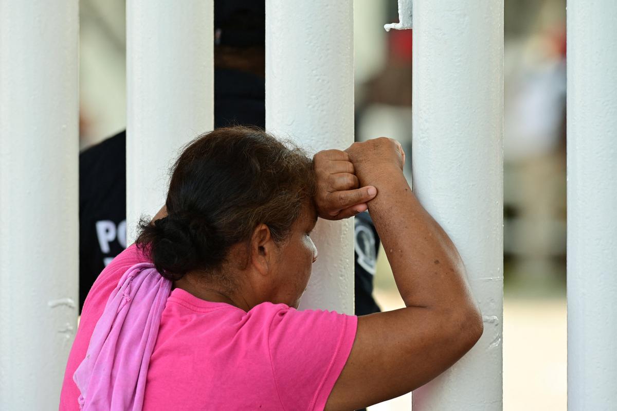The mother-in-law of a victim leans on a fence in the aftermath of a deadly fire at a large fairground venue where a music concert attended by thousands of people took place, in Villahermosa, Tabasco state, Mexico, May 7, 2026. REUTERS/Luis Manuel Lopez