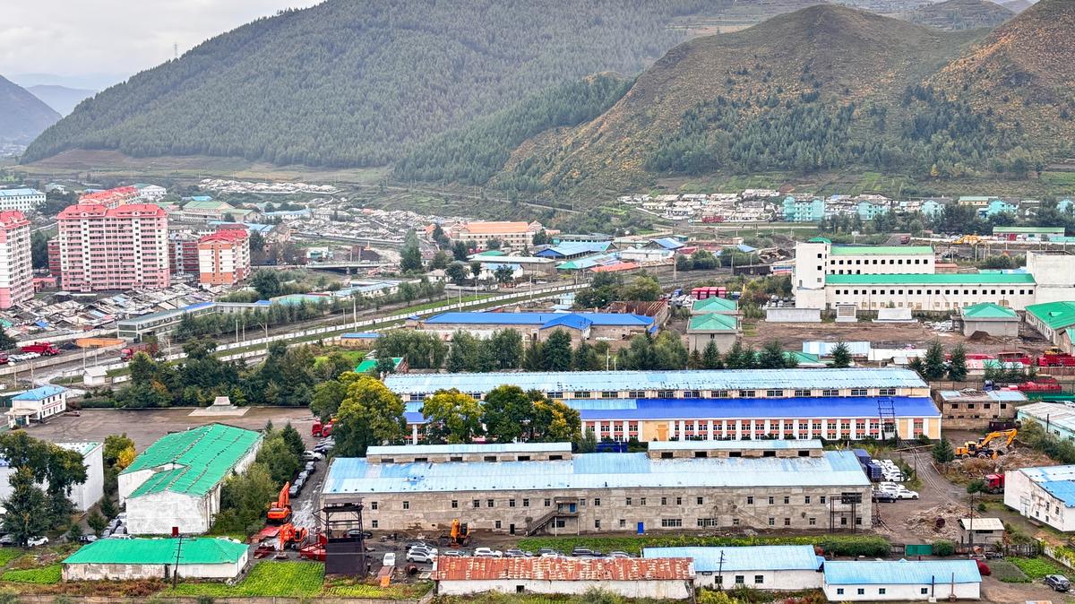 Cars are parked around buildings along the North Korean border in the city of Hyesan, North Korea, in this picture taken at the China side of the border in Changbai County, Jilin province, China, September 28, 2025. JOUNG EUN-LEE/via REUTERS