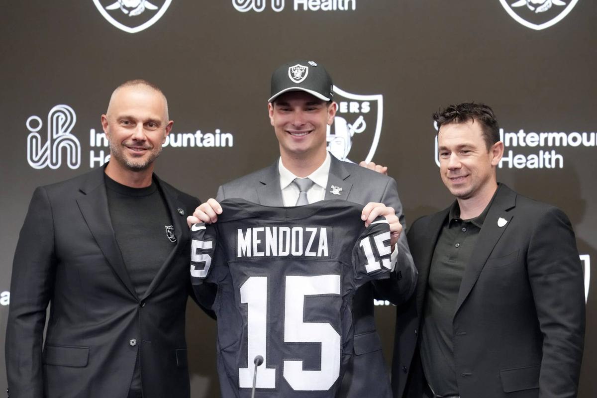  Apr 24, 2026; Henderson, NV, USA; Las Vegas Raiders quarterback Fernando Mendoza (center) poses with jersey with general manager John Spytek (left) and head coach Klint Kubiak at introductory press conference at Intermountain Health Performance Center after being selected as the No. 1 pick in the 2026 NFL Draft. Mandatory Credit: Kirby Lee-Imagn Images 