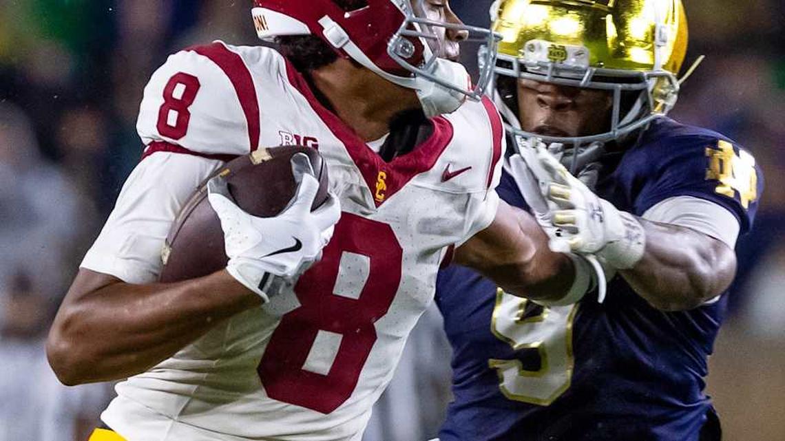  Oct 18, 2025; South Bend, Indiana, USA; Southern California Trojans wide receiver Ja'Kobi Lane (8) breaks a tackle by Notre Dame Fighting Irish safety Tae Johnson (9) during the second half at Notre Dame Stadium. Mandatory Credit: Michael Caterina-Imagn Images | Michael Caterina-Imagn Images 