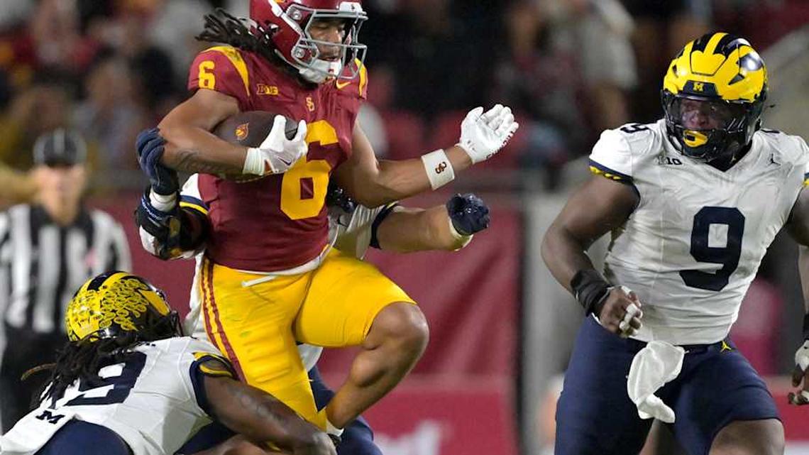  Oct 11, 2025; Los Angeles, California, USA; USC Trojans wide receiver Makai Lemon (6) runs for a first down before he is stopped by Michigan Wolverines linebacker Jimmy Rolder (30), defensive back Rod Moore (19) and defensive end Cameron Brandt (9) in the second half at United Airlines Field at the Los Angeles Memorial Coliseum. Mandatory Credit: Jayne Kamin-Oncea-Imagn Images | Jayne Kamin-Oncea-Imagn Images 