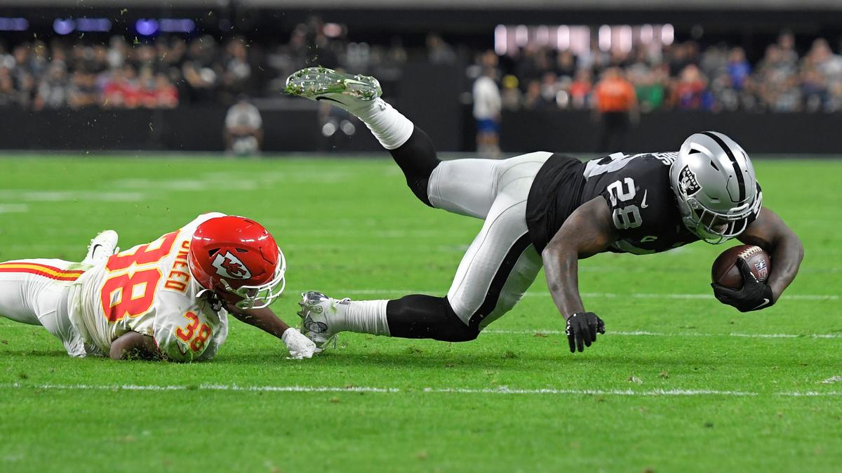 Kansas City Chiefs cornerback L’Jarius Sneed (38) tackles Las Vegas Raiders running back Josh Jacobs (28) during the first half of an NFL football game, Sunday, Nov. 14, 2021, in Las Vegas. (AP Photo/David Becker)