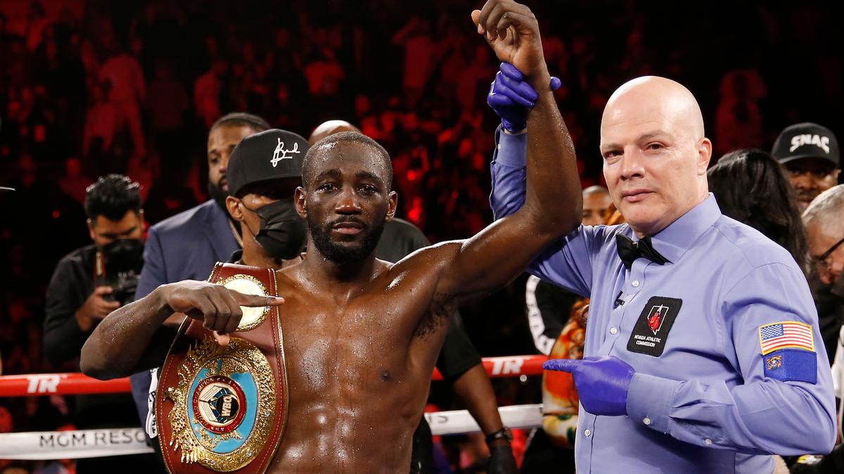 Terence Crawford poses for photographers after defeating Shawn Porter by TKO in a welterweight title boxing match, Nov. 20, 2021, in Las Vegas. There could be an undisputed and still undefeated welterweight champion in the not-so-distant future. The stage appears set for Errol Spence Jr. and Terence Crawford to finally get in the ring together. Soon after WBC and IBF champion Spence won his unification bout to take the WBA belt from Yordenis Ugás, WBO titleholder Crawford tweeted that it was time for the real fight. (AP Photo/Chase Stevens)