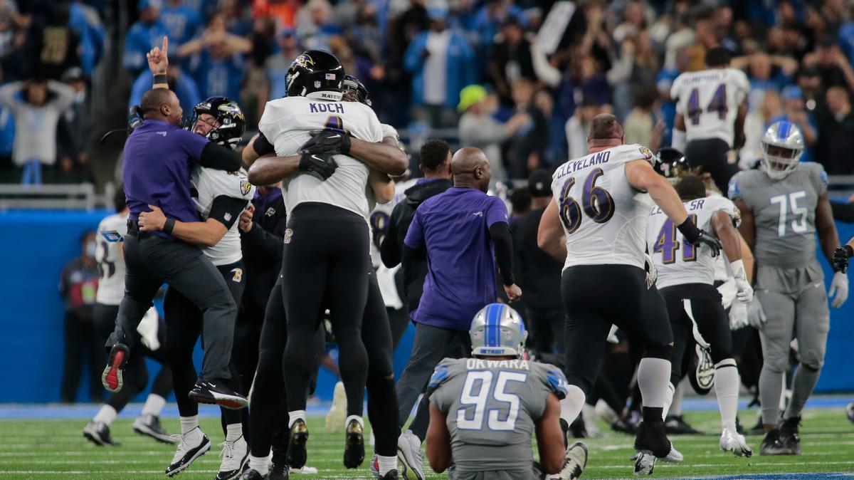 Baltimore Ravens players celebrate a Justin Tucker 66-yard field goal as Detroit Lions linebacker Romeo Okwara (95) sits on the field in the second half of an NFL football game against the Detroit Lions in Detroit, Sunday, Sept. 26, 2021. Baltimore won 19-17. (AP Photo/Tony Ding)