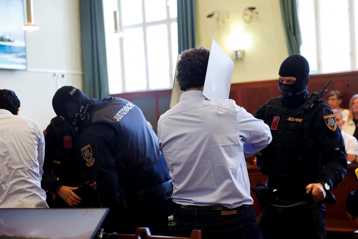 Austrian defendant identified as Beran A, suspected of planning an attack on U.S. singer Taylor Swift's Vienna concert in 2024, is escorted by security personnel in a courtroom for his trial in Wiener Neustadt, Austria, May 28, 2026. REUTERS/Lisa Leutner